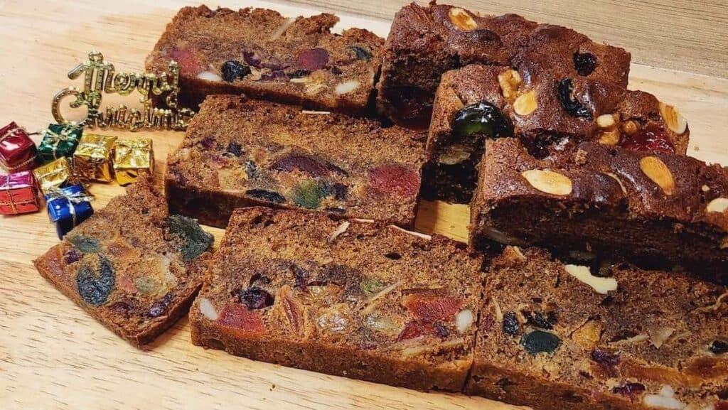 a photo of english fruit cake slices on a wooden plate from a different angle.