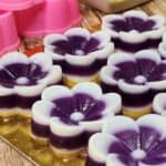 Kuih talam ubi ungu or purple sweet potato on a golden tray.