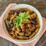 A plate of eggplant with ground pork stir fry on pink and white napkin.