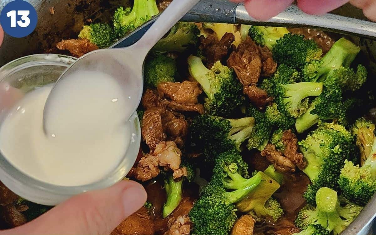 Putting cornstarch slurry into the wok.