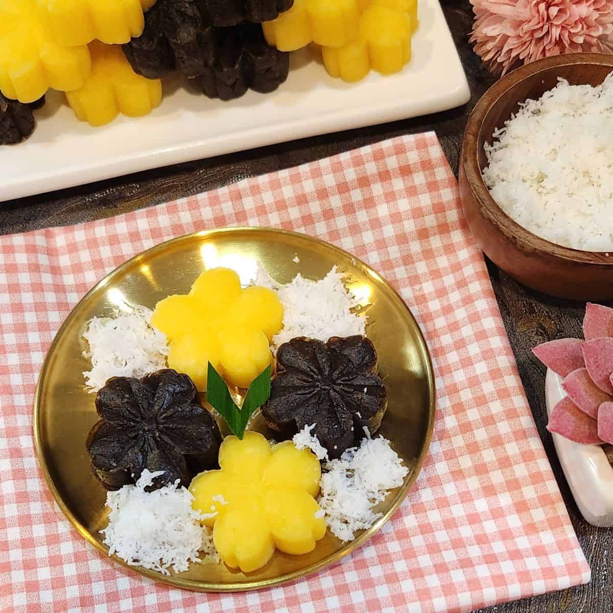 A golden plate of getuk lindri with grated coconut.