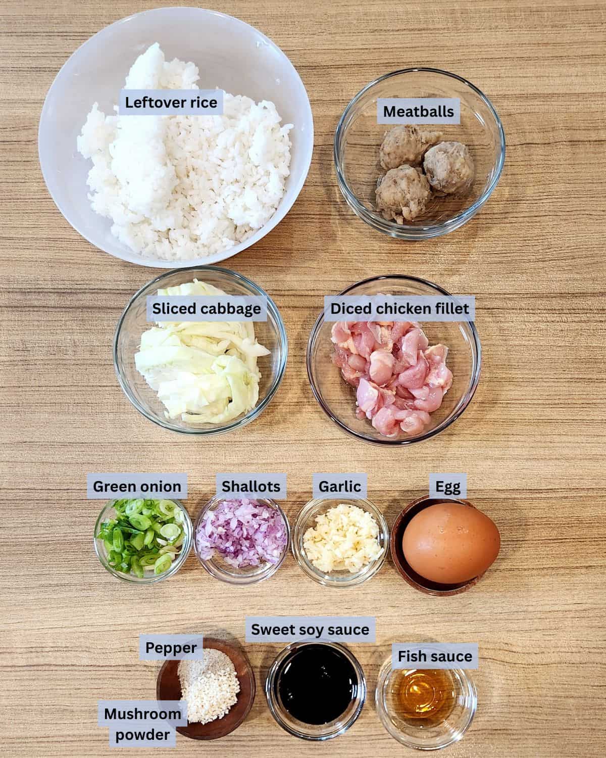 Nasi goreng kampung ingredients in bowls with labels.