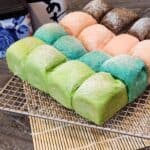 Colorful Japanese Milk Buns on a wire rack.