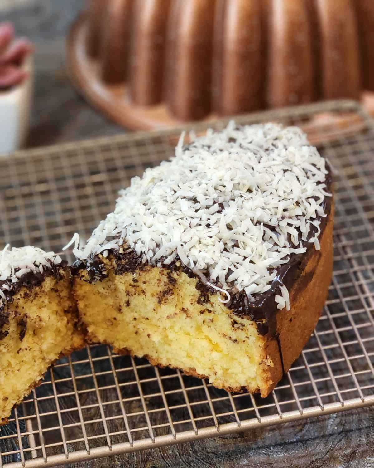 Coconut Pound Cake with chocolate glaze and coconut flakes.