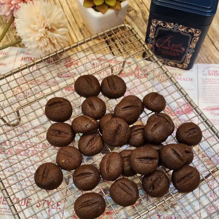 Several coffee bean cookies on a wire rack.