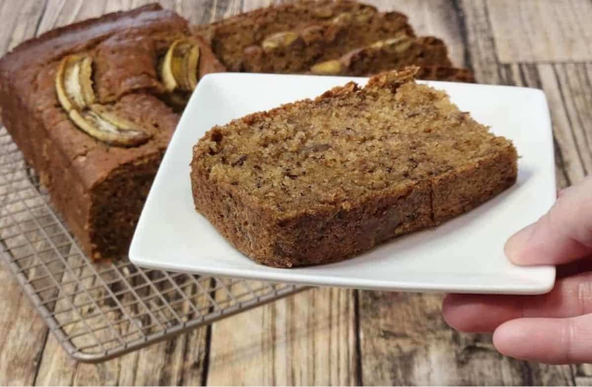 A slice of copycat starbucks banana bread on a white plate.