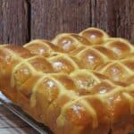 Hot cross buns on a steel rack.