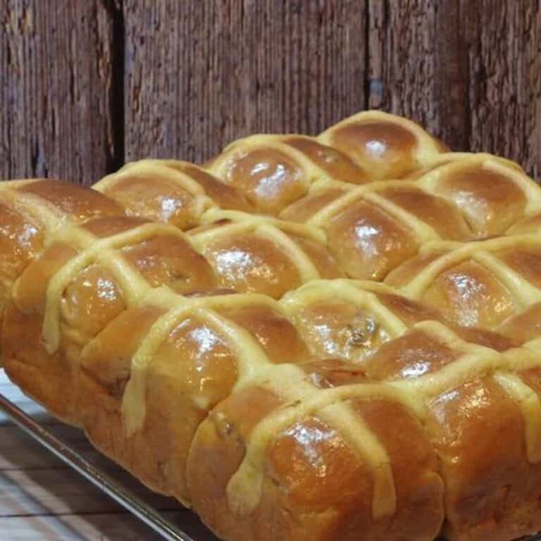 Hot cross buns on a steel rack.