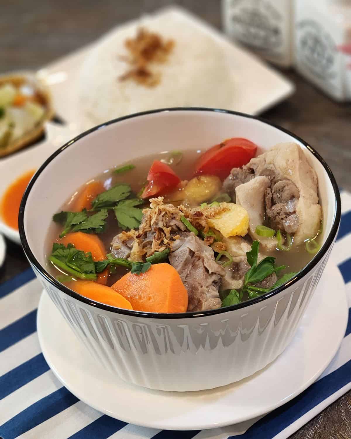 A bowl of Indonesian oxtail soup or sop buntut.