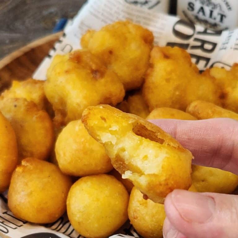 A hand holding perkedel Fried Mashed Potato Patties.
